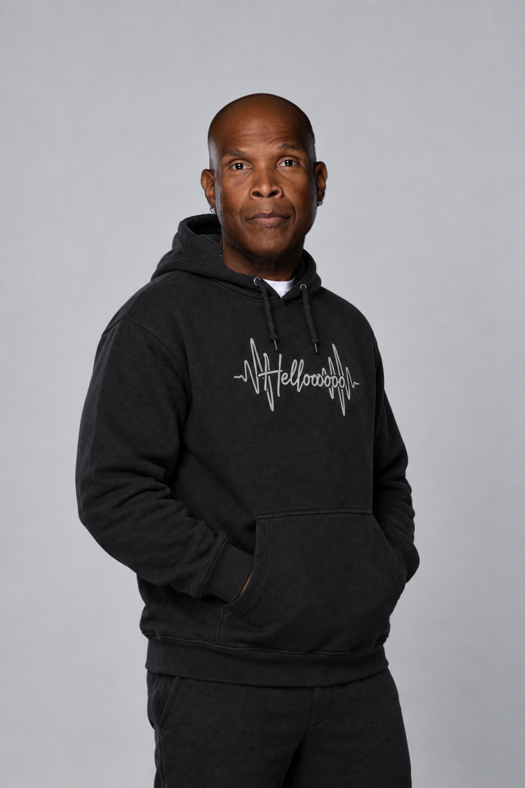 HELLOOOOO black hoodie with silver grey print — three-quarter model view