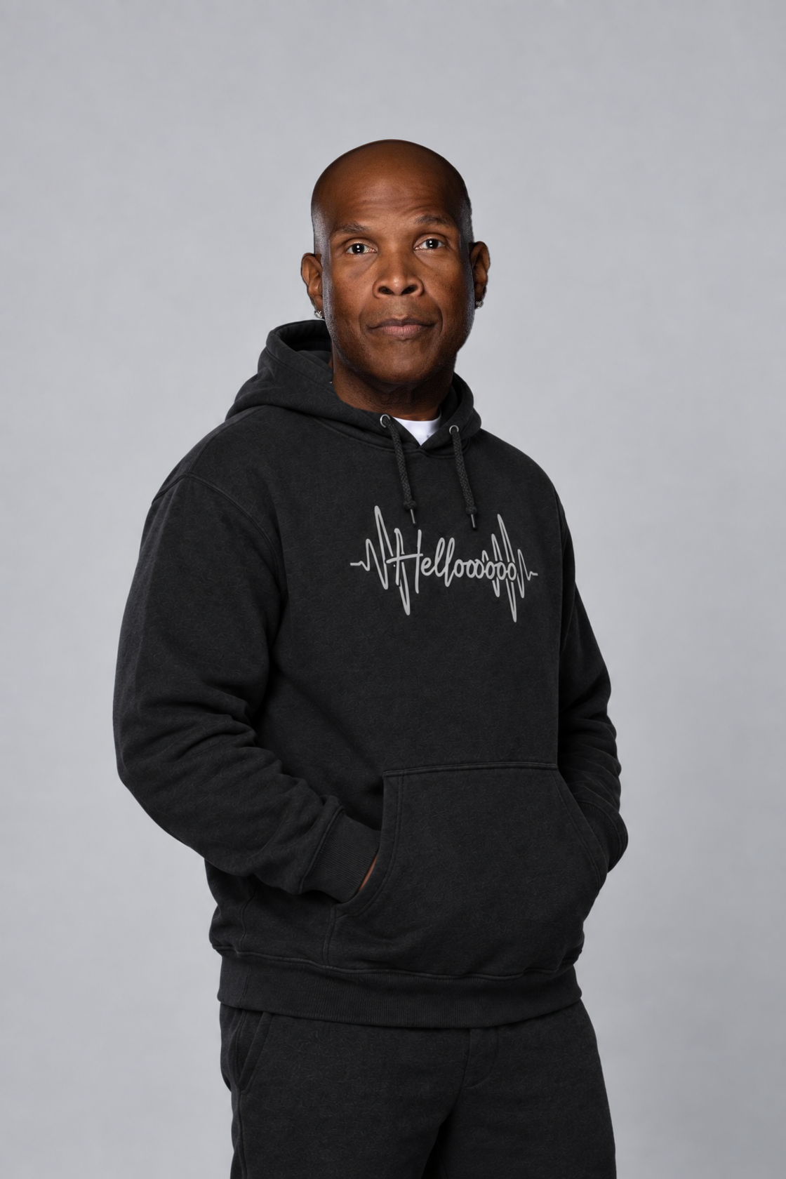 HELLOOOOO black hoodie with silver grey print — three-quarter model view
